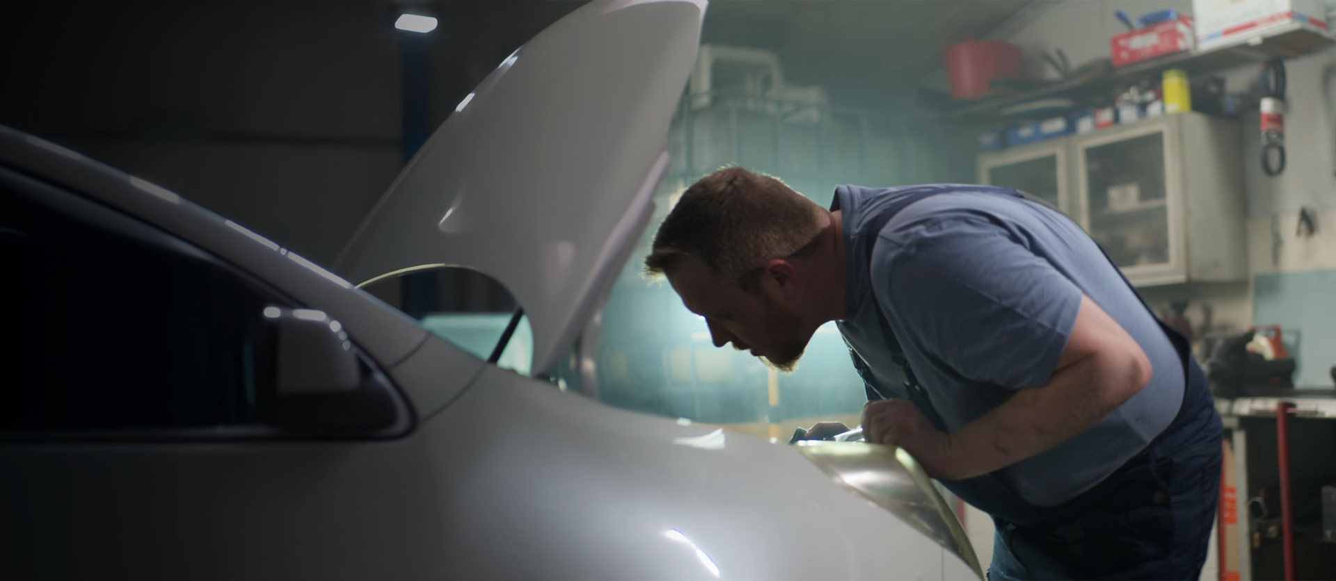 Mechanic looking in car