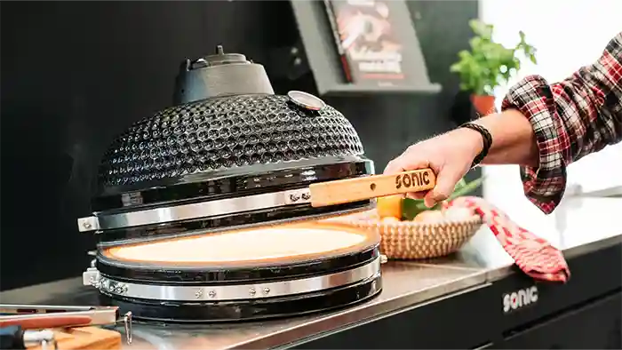 hand opening Sonic Kamado BBQ